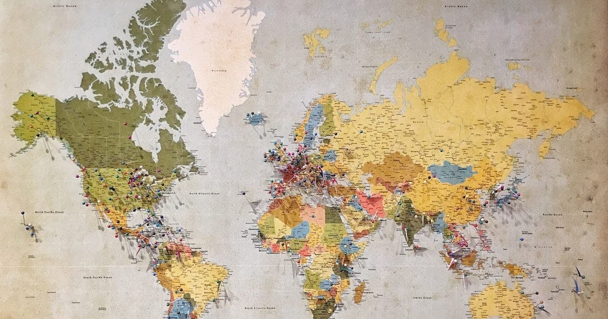 A dark-themed interactive 3D globe covered in glowing visited and wishlist travel pins